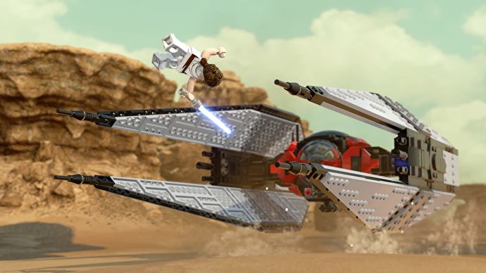 Lego Rey jumps over a Tie Fighter on the sands of Tatooine in Lego Star Wars The Skywalker Saga