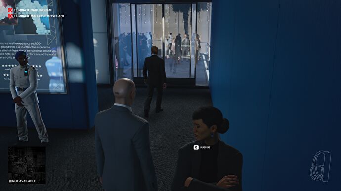 Agent 47 watches as a man approaches a glass door in Hitman 3.