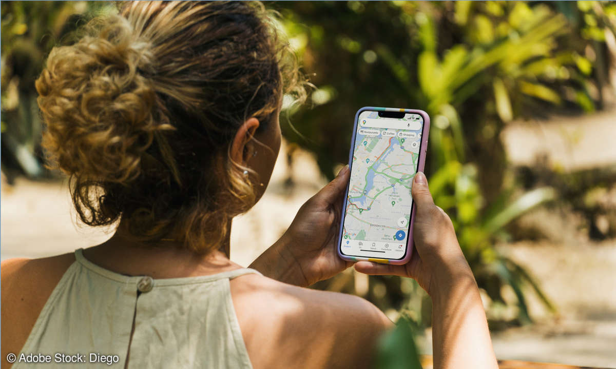 Woman uses Google Maps on her smartphone in a park