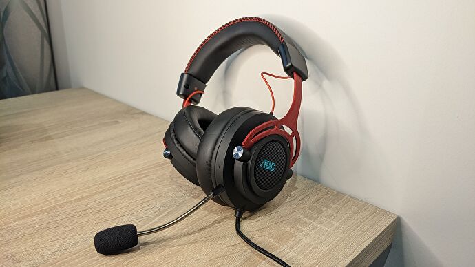 The AOC GH300 gaming headset on a desk.