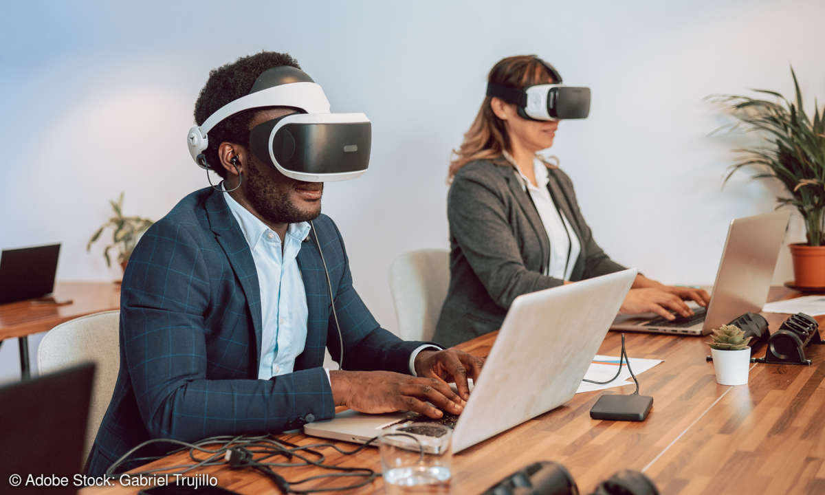 Man and woman using VR headset at an office desk