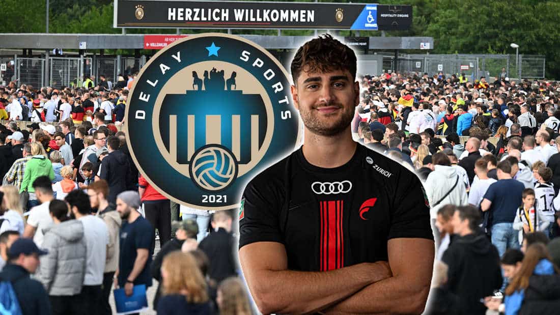 Elias Nerlich stands next to the Delay Sports Berlin logo