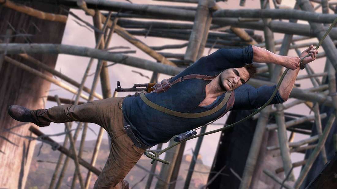 Nathan Drake, the main protagonist of most Uncharted games, swings through a construction site on a rope.