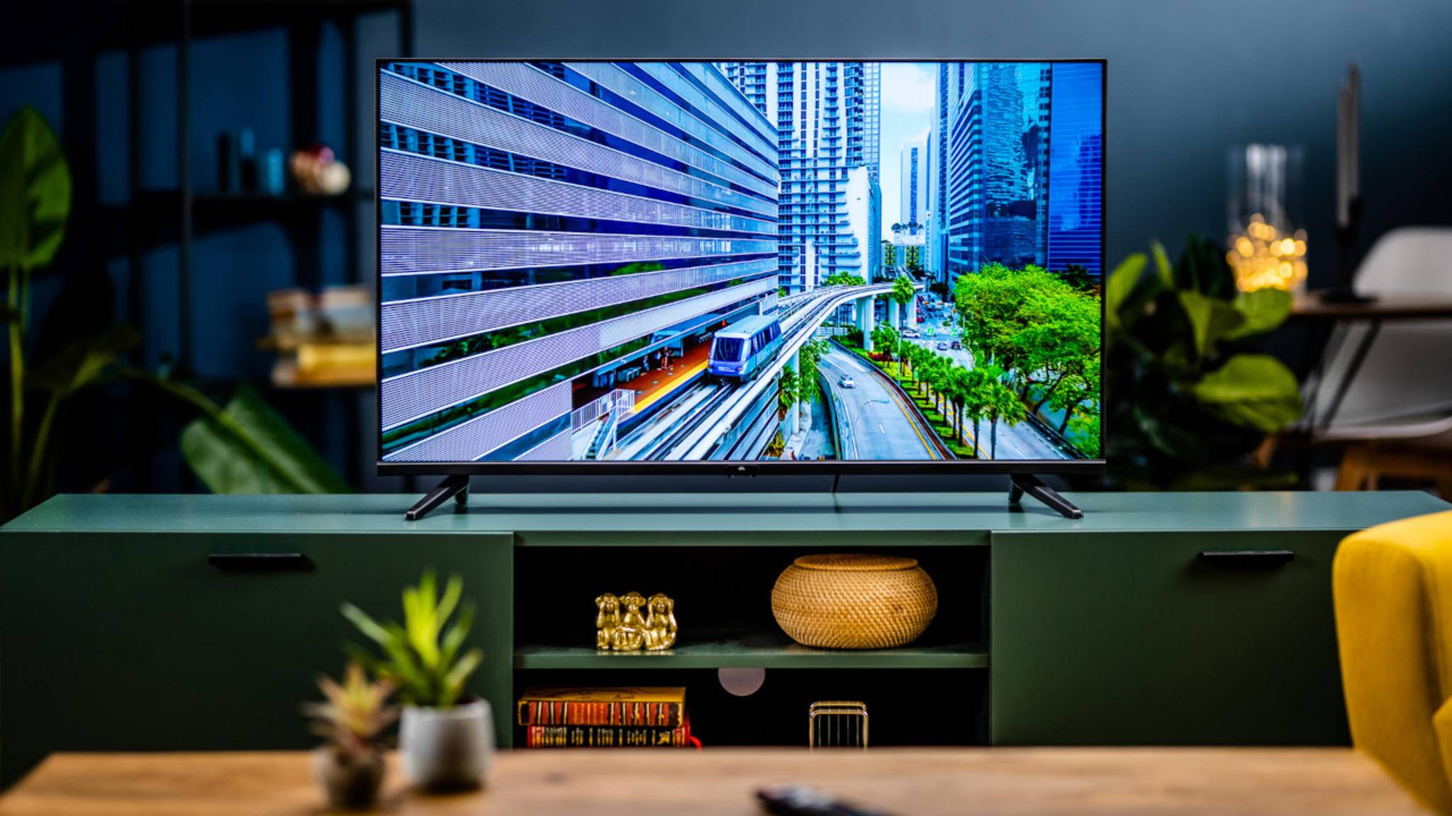 40 inch TV stands on a TV stand.  It shows a bright blue image.