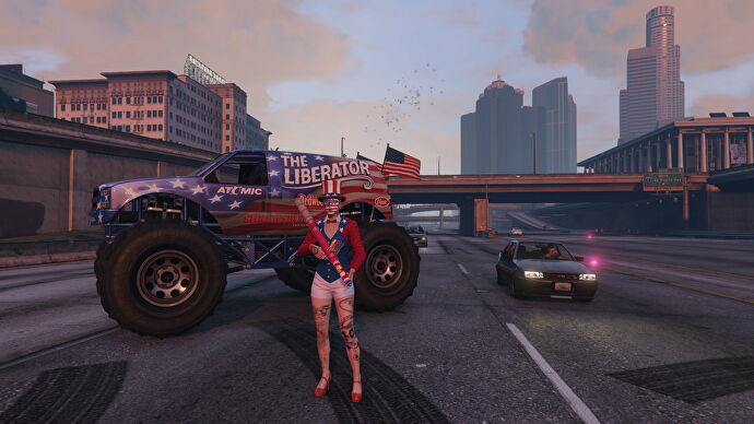 A woman dressed in a patriotic American costume holds a firework baooka in front of a monster truck daubed with the stars and stripes in a GTA Online screenshot.