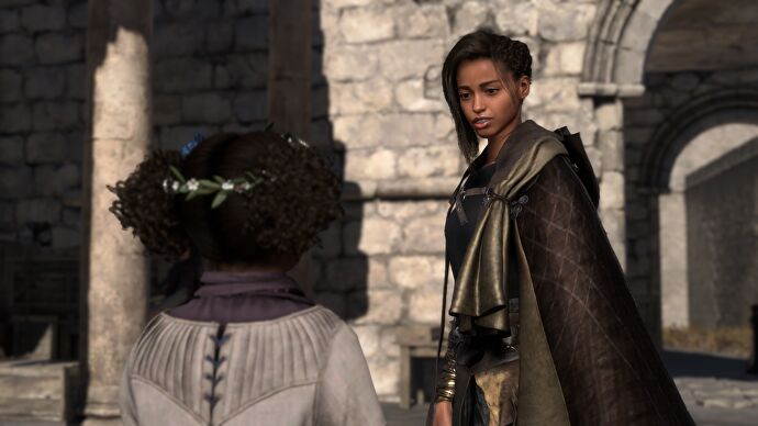 Clad in her new cloak, Frey speaks to a young pickpocket in Forspoken.