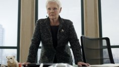Judi Dench in her role as "M"  stands in front of a desk in her office as head of MI6.